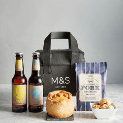 Two bottles of beer, pork pie, pie shreds and a cooler bag