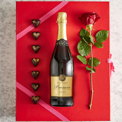 Red book style giftbox with prosecco, caramel hearts and single rose